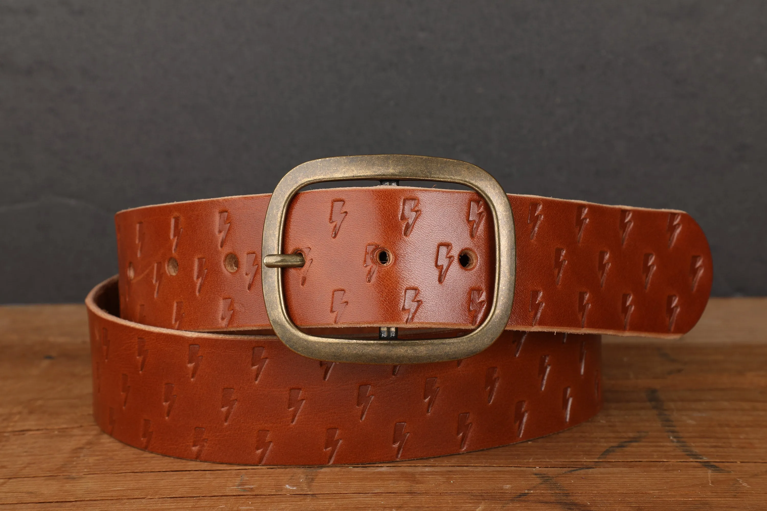 Medium Brown Bridle Leather Belt with Embossed Lightning Bolts and Antique Brass Buckle